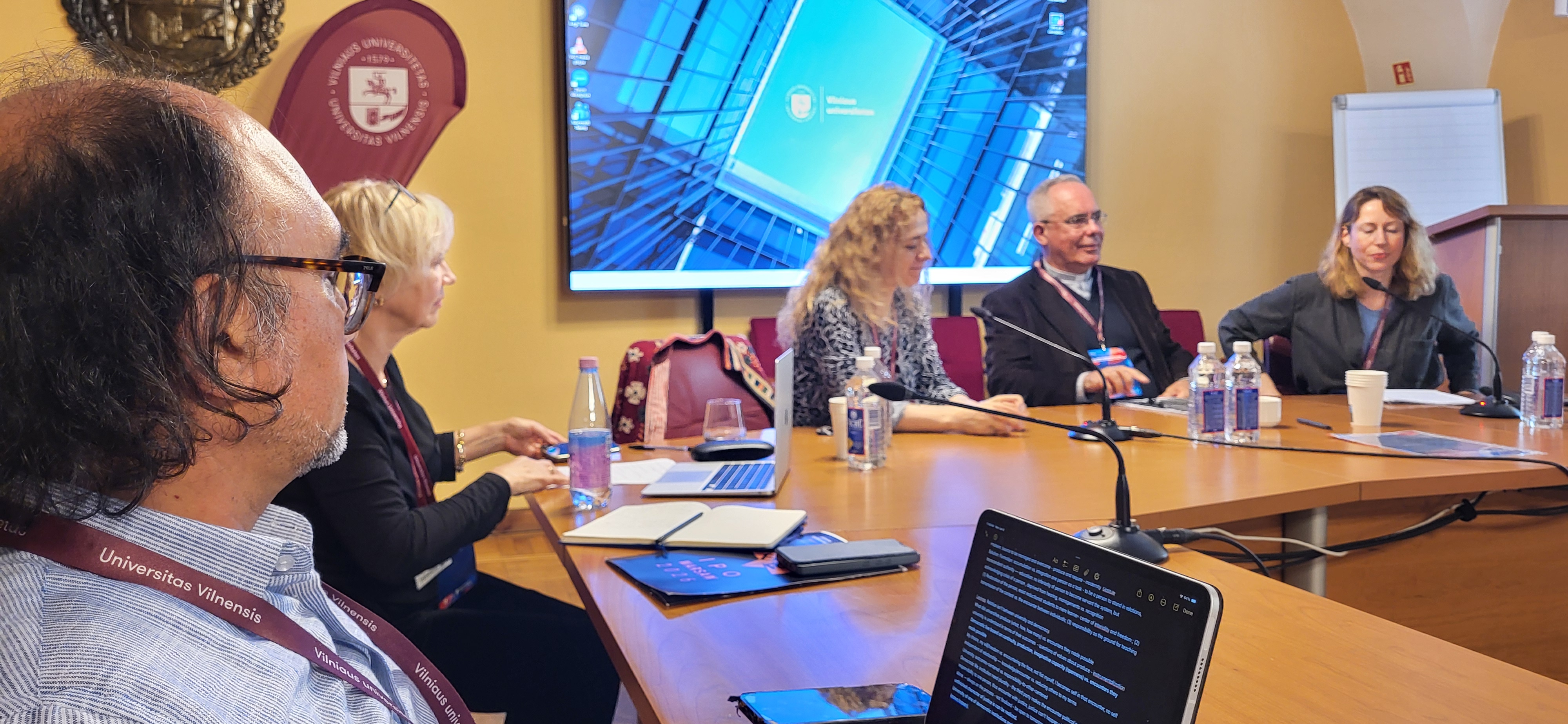 Scholars around a table discussing values